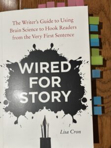 Cover of the book *Wired for Story* by Lisa Cron. A plethora of marked pages.